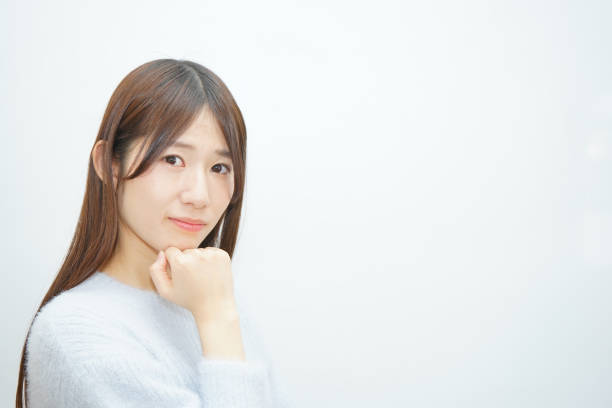 istock Young woman thinking something with white background 641856006