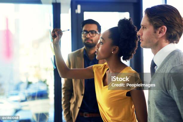 Developing A Plan Of Action Stock Photo - Download Image Now - Teamwork, Office, Multiracial Group