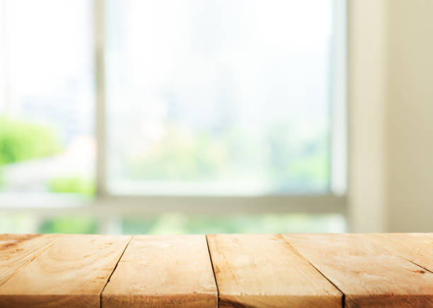 istock Wood table top on blur green garden from window view. 641863964
