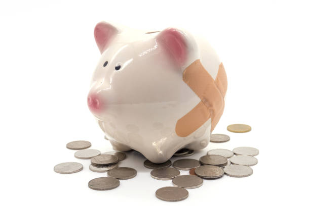 istock stethoscope with pink piggy bank and coins 641864850