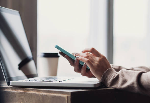 istock Businesswoman is using smart phone and laptop 641866102