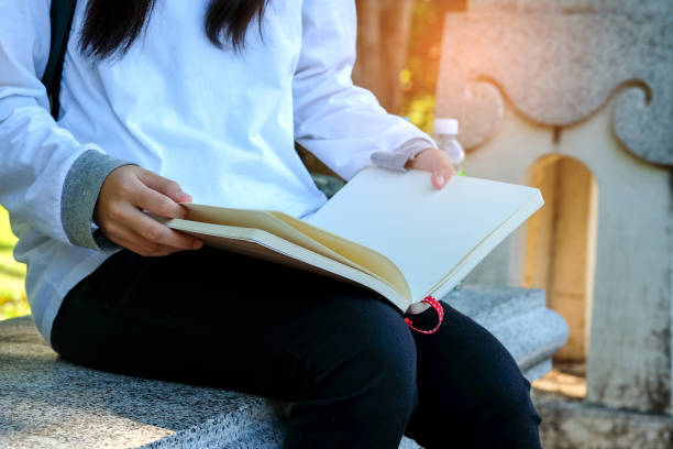 istock Girl sitting on a chair reading a book. 641868334