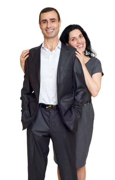 istock romantic couple hugging, dressed in black suit, isolated white 641870480