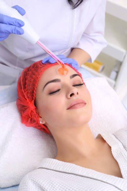 istock Receiving electric darsonval facial massage procedure. 641871078