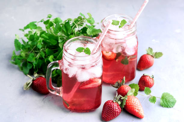 istock Strawberry lemonade with ice and mint in glass mug jars 641871402