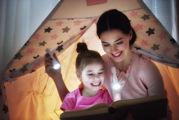 istock Mom and child are reading book 641872158