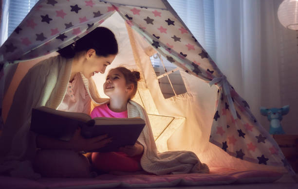 istock Mom and child are reading book 641872186