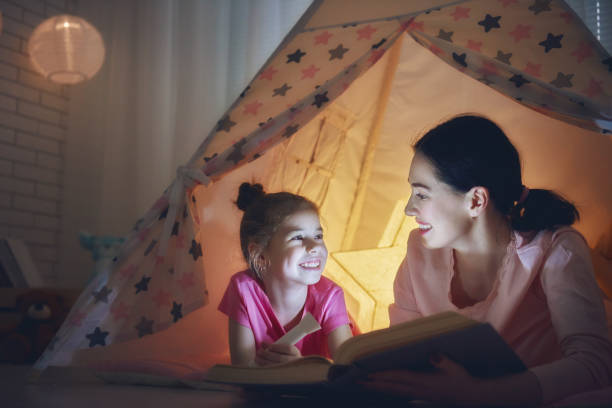 istock Mom and child are reading book 641872236