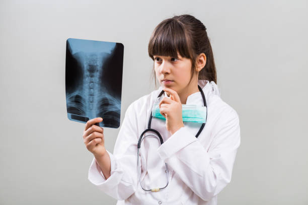 istock Little doctor holding x-ray 641873234