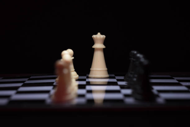 istock One  chess pieces staying against black chess pieces 641874348