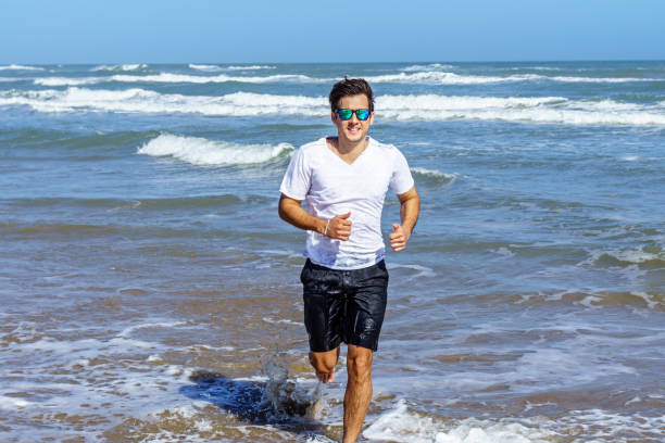 istock Brazilian man running at the seashore 641875972