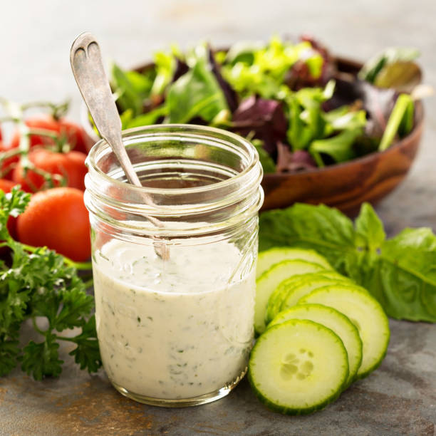 Homemade ranch dressing in a mason jar Homemade ranch dressing in a mason jar with fresh vegetables salad dressing photos stock pictures, royalty-free photos & images