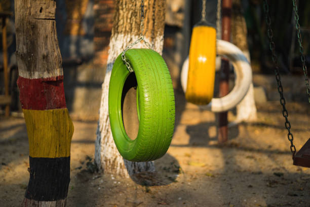 Swing chairs made from old tires  for children in park.