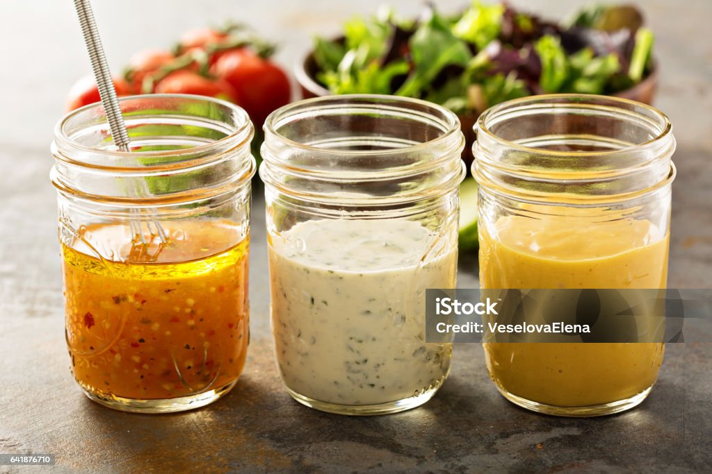 Variety of sauces and salad dressings Variety of homemade sauces and salad dressings in mason jars including vinaigrette, ranch and honey mustard Salad Dressing Stock Photo