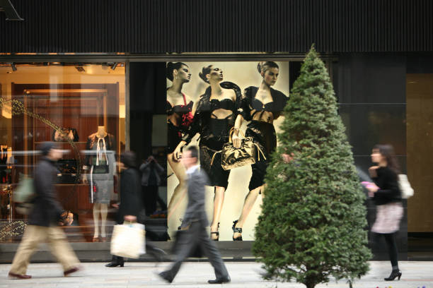 Tokyo, Japan - March 24, 2009: pedestrians walk past a shop window in Ginza. Ginza is the main area of boutiques in Tokyo.