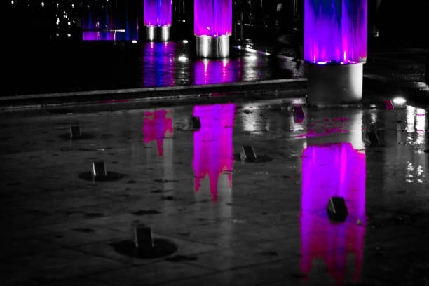 Abstract lighting on the rain soaked paving near the marina and wharf areas in central Bristol.
