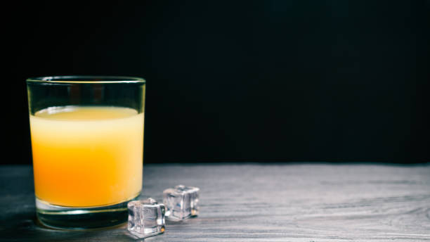 istock Orange juice on dark background 641881384