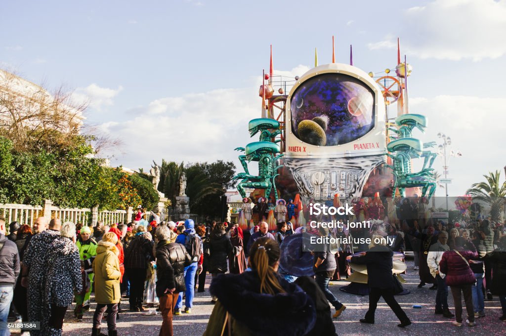 Viareggio, first parade of carnival,Italy Viareggio,Italy-February,12,2017: first parade of the 2017 viareggio's carnival, with typical float and people masked  parade in the seaside boulevard of the italian resort of viareggio.The satyrical carnival this year points finger to Donald Trump carachter with many mask and float dedicate to him.General moment of the parade in the photo 2017 Stock Photo