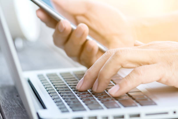 istock hand working with laptop and smartphone 641884384