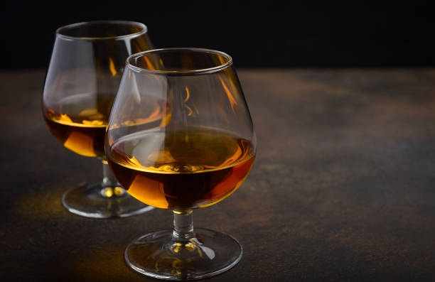 istock Glass of brandy or cognac on the old rusty background 641884734