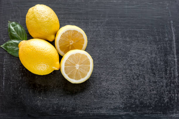 istock Fresh lemons on the dark wooden background 641884834