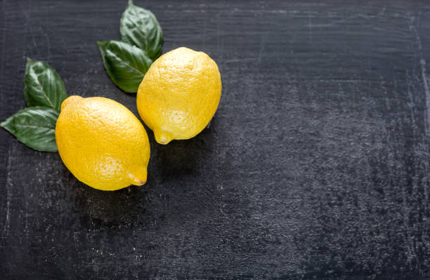 istock Fresh lemons on the dark wooden background 641884856