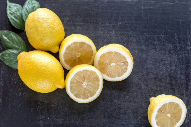 istock Fresh lemons on the dark wooden background 641884976