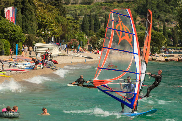 Windsurfers on Lake Garda, the largest Italian lake, located on the northern of the country. The lake, thanks to the constant wind, is well known among the windsurfing, kite surfing and sailing enthusiasts.