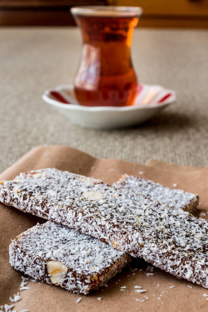 istock Turkish Dessert Cezerye with walnut, coconut powder and tea. 641890434