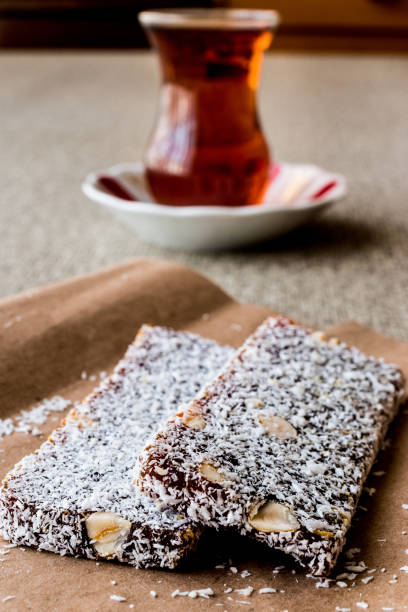 istock Turkish Dessert Cezerye with walnut, coconut powder and tea. 641890694
