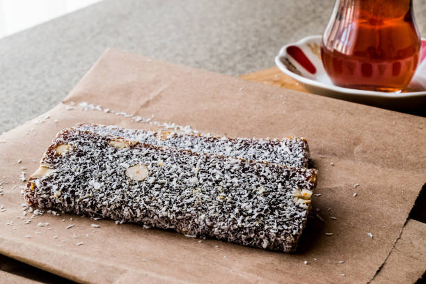 istock Turkish Dessert Cezerye with walnut, coconut powder and tea. 641891528