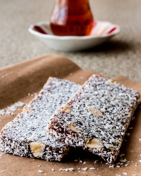 istock Turkish Dessert Cezerye with walnut, coconut powder and tea. 641891896