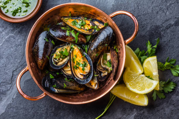 istock Mussels in copper bowl, lemon, herbs sauce and white wine. 641892488