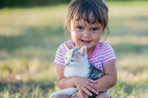 istock Young Girl Cuddles a Kitten 641895326