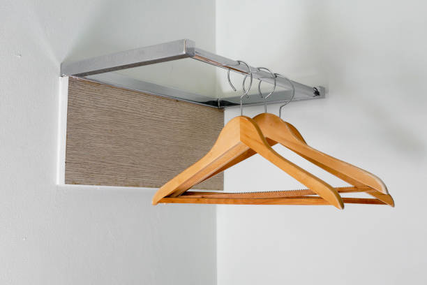 istock Clothes hangers at a white pianted concrete wall 641898800