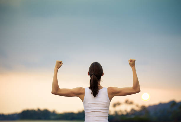 istock Strong and confident woman flexing her muscle. 641899244