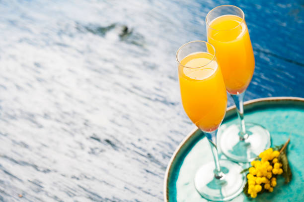 Mimosa cocktail Two glasses with mimosa cocktail (sparkling wine plus orange juice) acacia tree photos stock pictures, royalty-free photos & images