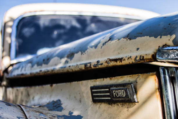 St. Kilda, Melbourne, Australia - October 25, 2015: insignia of Ford Motor Company on the hood of an abandoned Ford Prefect.