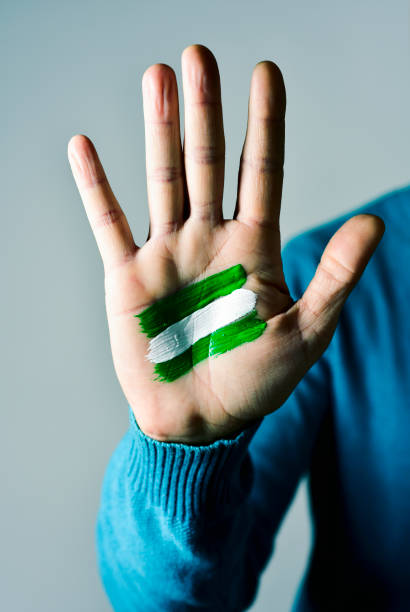 the flag of Andalusia, Spain, painted in the palm of a young caucasian man