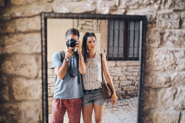 istock Photographer couple walking in Rovinj on a summertime day 641908552