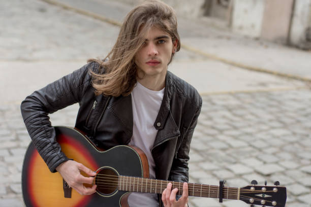 istock Guitar player playing song outdoor 641911618