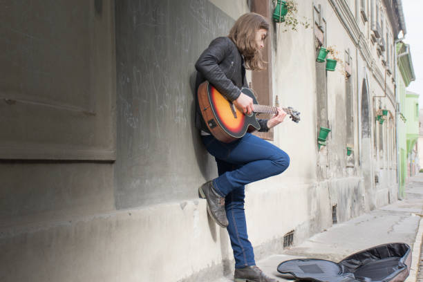 istock Guitar player playing song outdoor 641911728