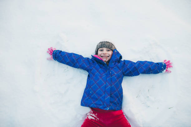 istock Angel Making Snow Angel 641918888
