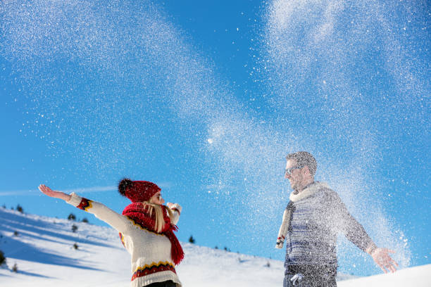 istock Winter couple having fun playing in snow outdoors. 641919764