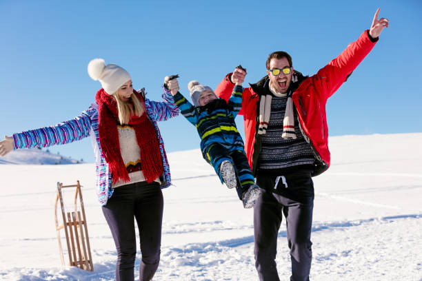 istock Attractive family having fun in a winter park on mountain 641920798