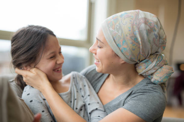 istock Mom with cancer holding daughter 641924822
