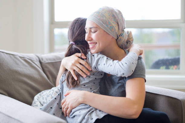 istock Mom with cancer holding daughter 641924824