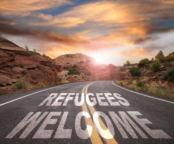 istock Empty Road with REFUGEES WELCOME text at Sunrise 641924858