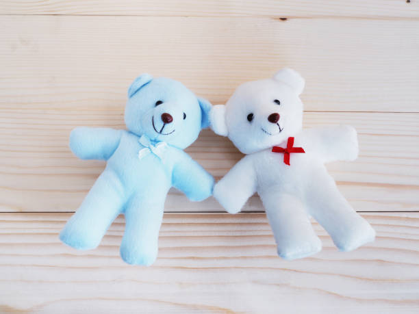 istock Blue and white toy teddy bear on wooden background 641924864