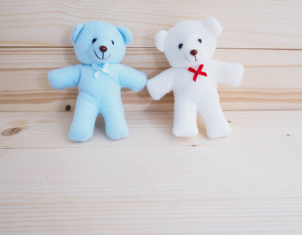 istock Blue and white toy teddy bear on wooden background 641924870